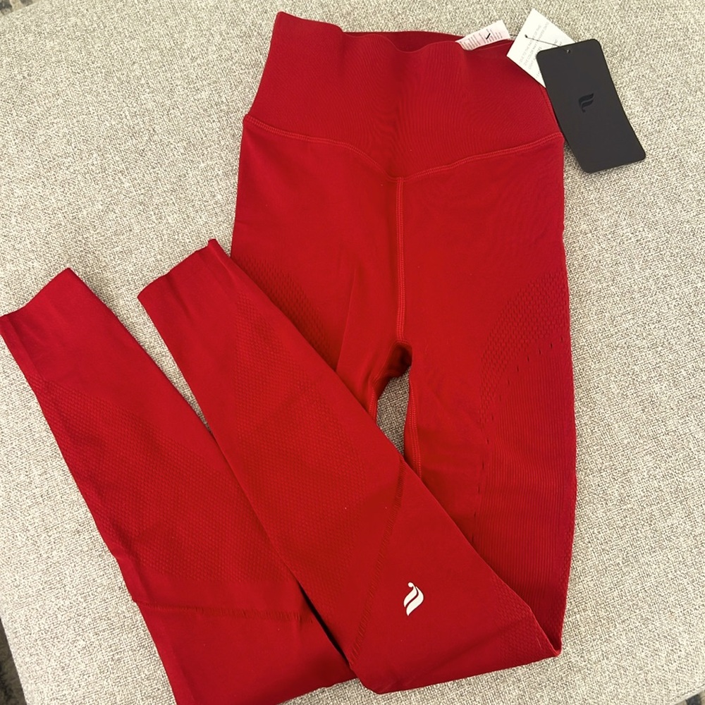 Red Fabletics leggings with cutout pattern in legs. Size small. Never worn!